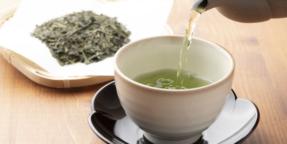 warm green tea on a wooden table