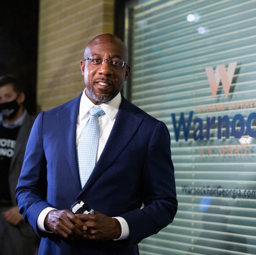 atlanta, ga   november 03 democratic us senate candidate rev raphael warnock greets supporters and staff as he enters his campaign headquarters on november 3, 2020 in atlanta, georgia democratic senate candidate rev raphael warnock is running in a special election against a crowded field, including us sen kelly loeffler r ga, who was appointed by gov brian kemp to replace johnny isakson at the end of last year georgia is the only state with two senate seats on the november 3 ballot photo by jessica mcgowangetty images