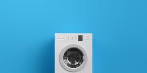 washing machine at blue wall, frontal view with copy space,3d rendering general design and captions