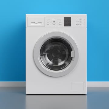 Washing machine at blue wall, frontal view with copy space,3d rendering (general design and captions)