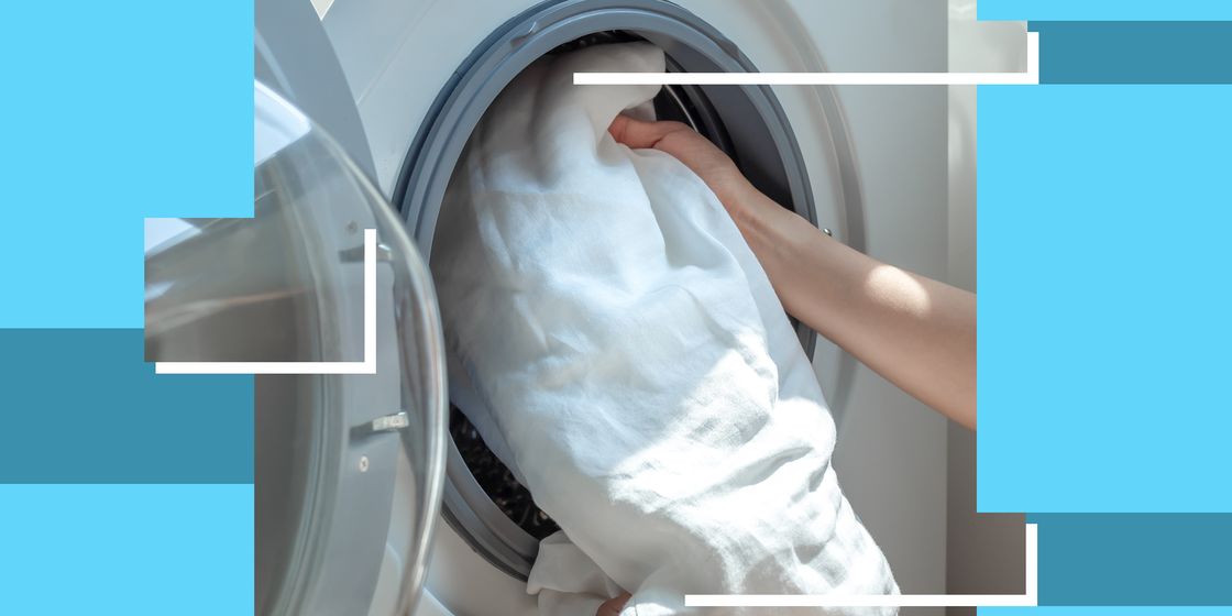 person loading sheets into a washing machine
