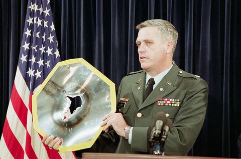 Army Colonel Holding Burnt Aluminum