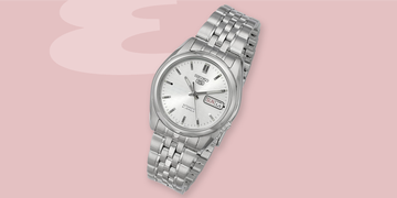 a silver watch with a white face