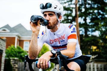 trevor raab sitting on his bike drinking from a water bottle