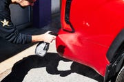 spray turtle wax 3 in 1 waterless clean on side of red truck