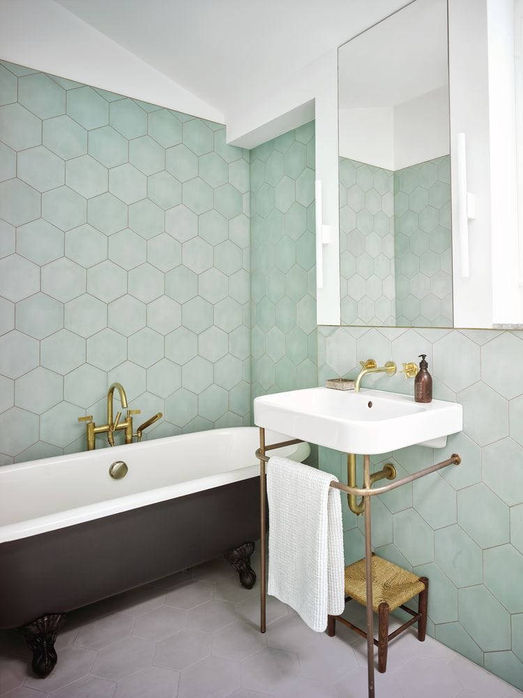 Bathroom with large hexagonal Bert & May tiles in mint, with traditional roll top bath and washstand