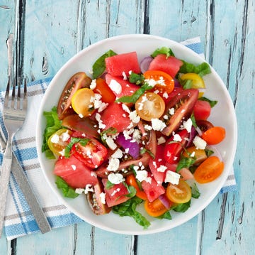 watermelon and tomato salad with feta, overhead on blue wood