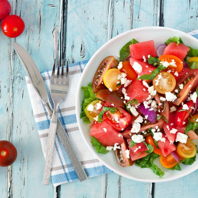 watermelon and tomato salad with feta, overhead on blue wood