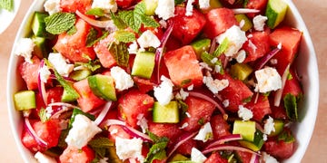 watermelon cubes, feta, red onion, and mint in a bowl