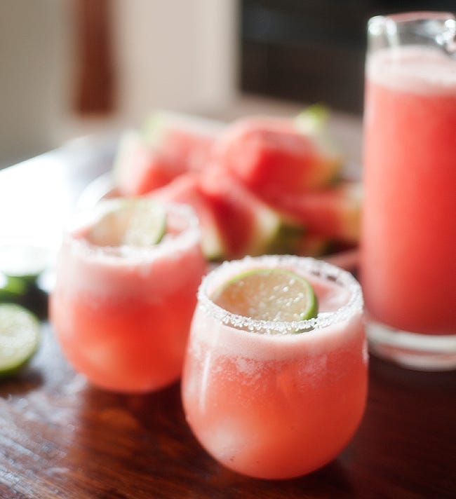 a pink watermelon margarita with a salted rim glass