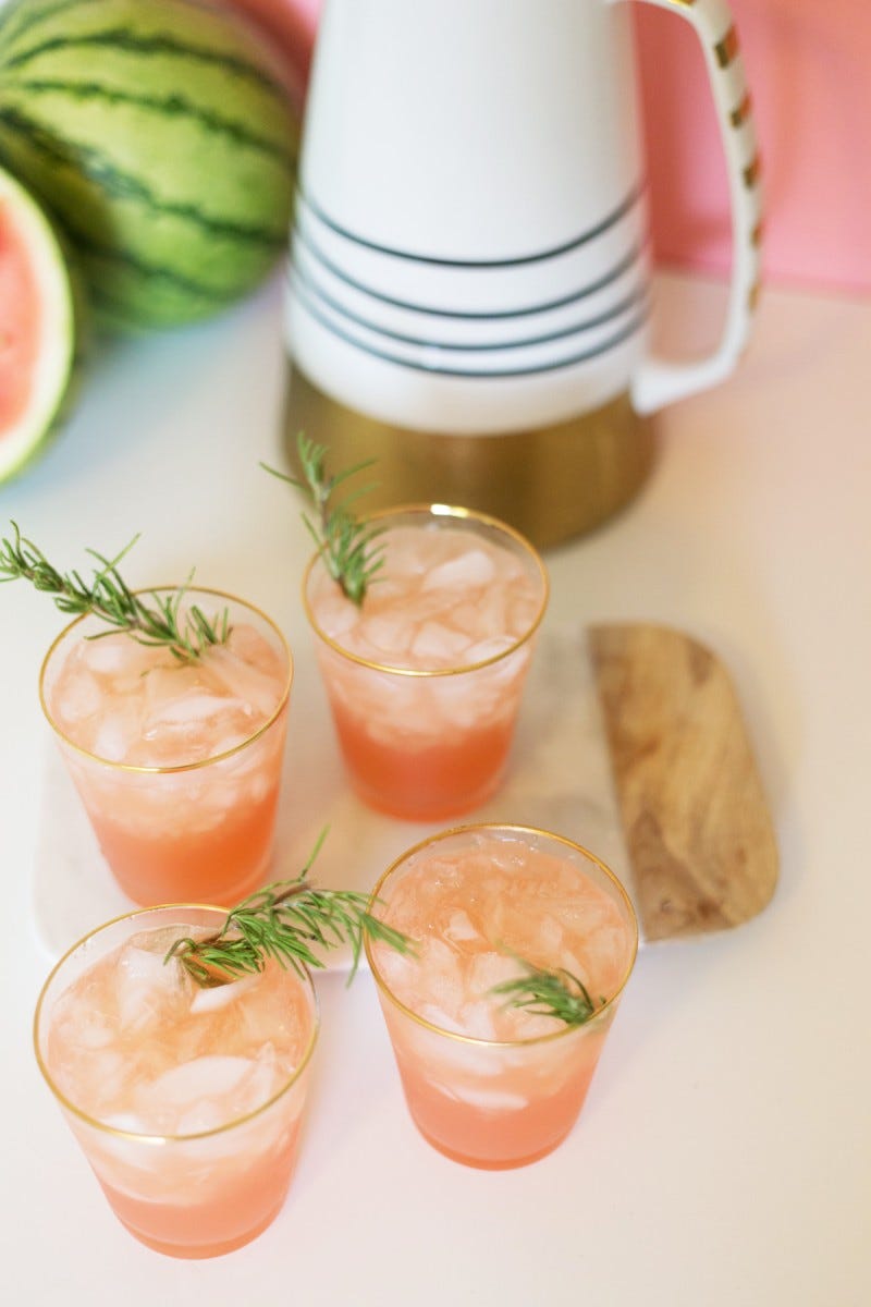 pink rosemary watermelon cocktails in clear glasses