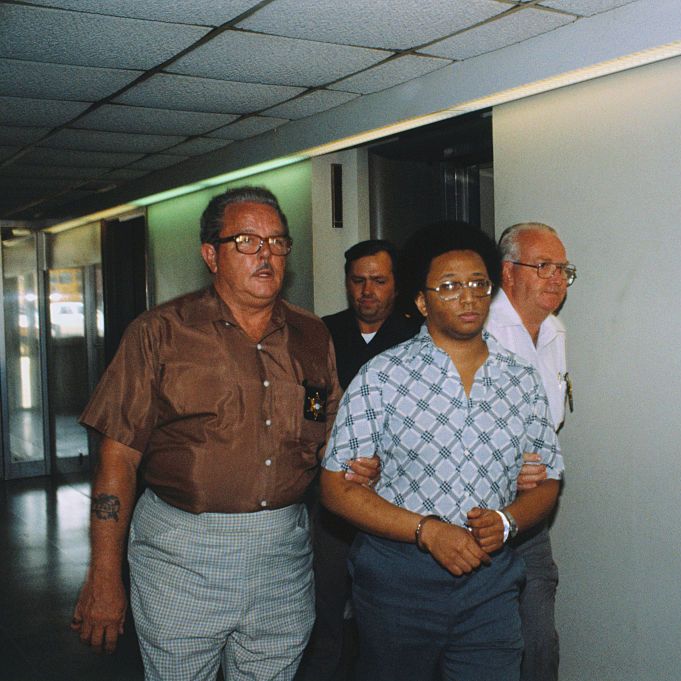Men Leading Wayne Williams in Handcuffs