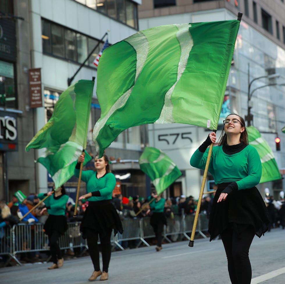 st patricks day activities st patricks day parade with performers holding green flags