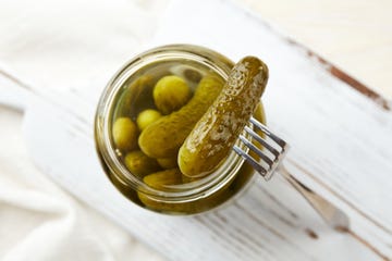 ways to use pickle juice pickles in a jar on a light wooden background. homemade pickles.