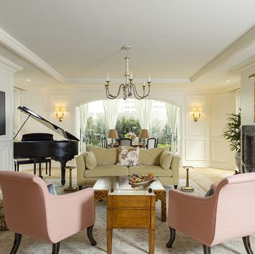 a living room with a piano and couches