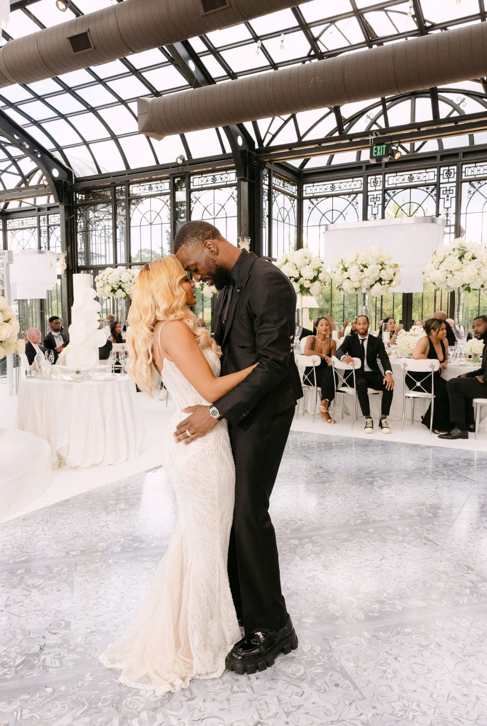 a bride and groom have their first dance