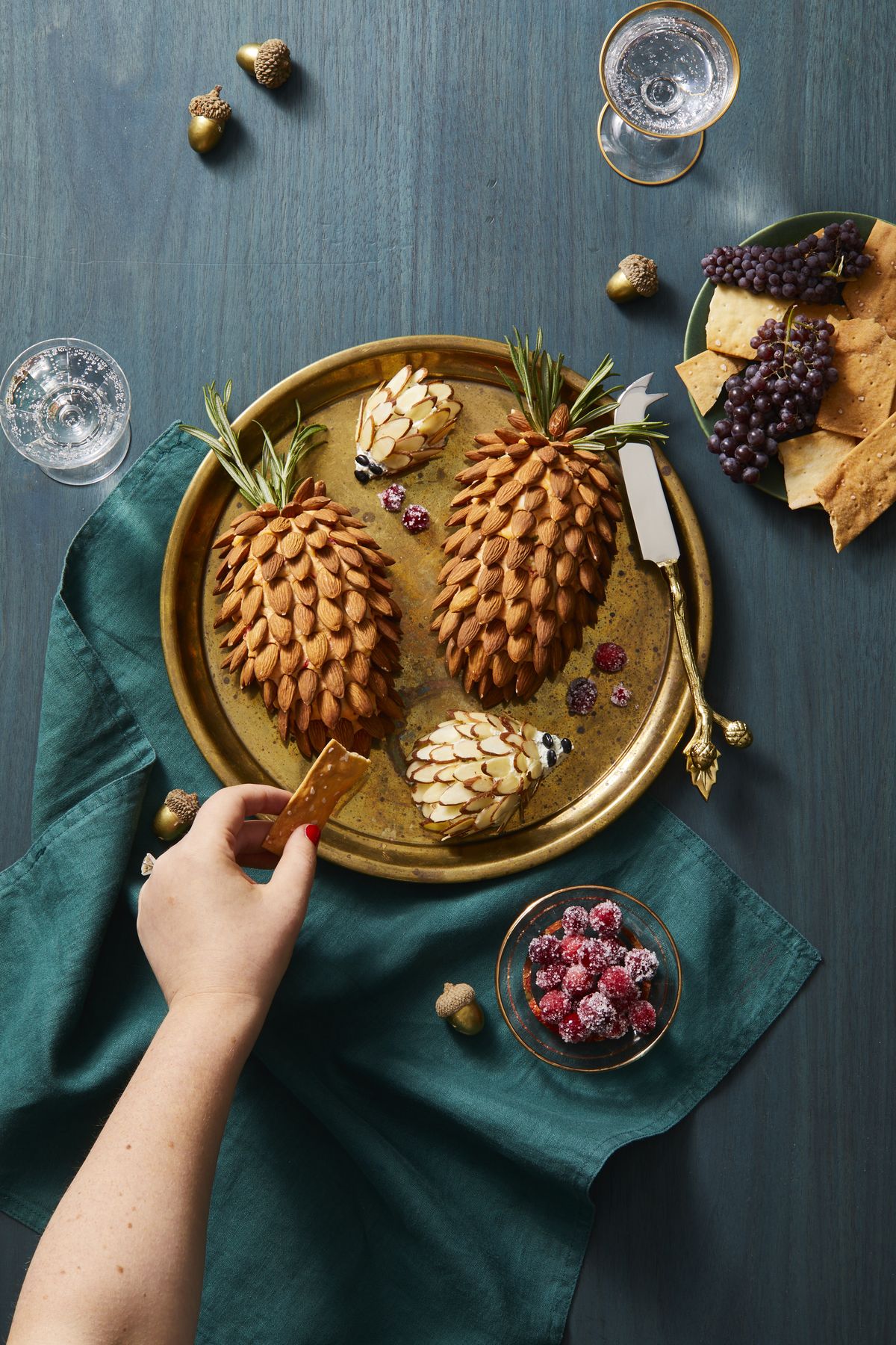 cheeseballs covered with almonds to resemble pinecones and hedgehogs