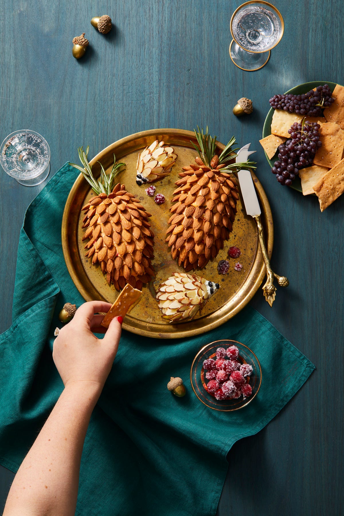 cheeseballs covered with almonds to resemble pinecones and hedgehogs