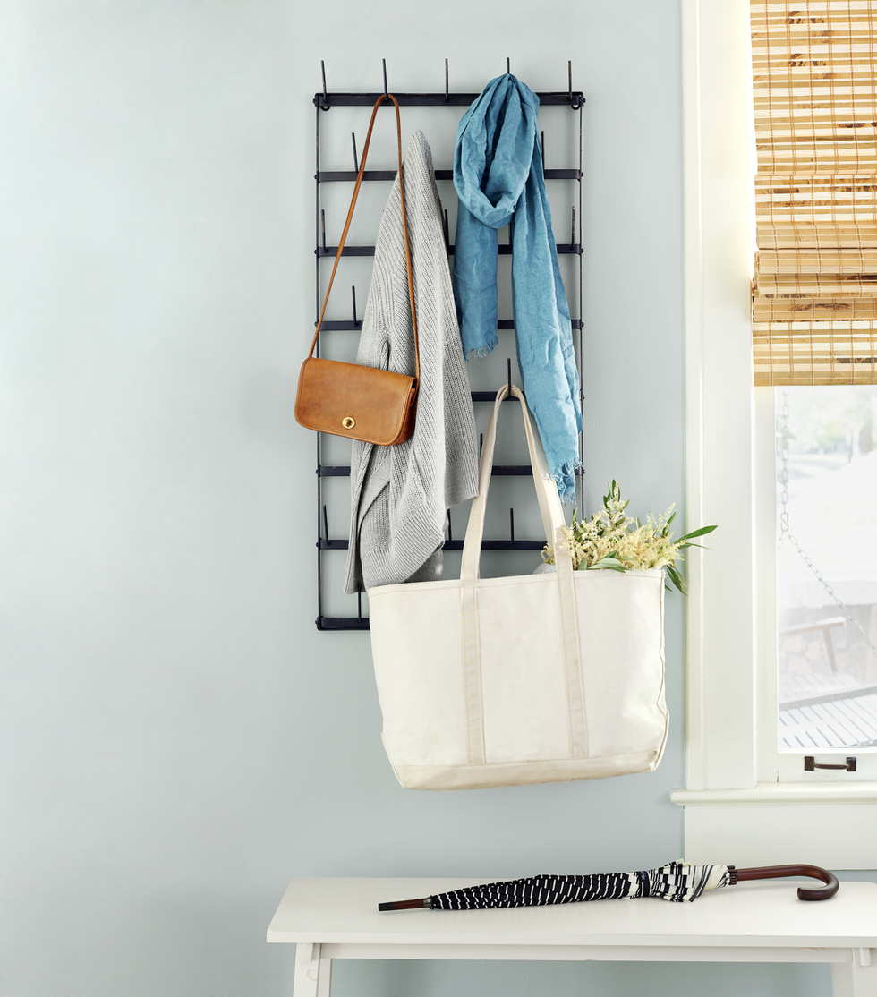 entryway with hanging purse and sweater