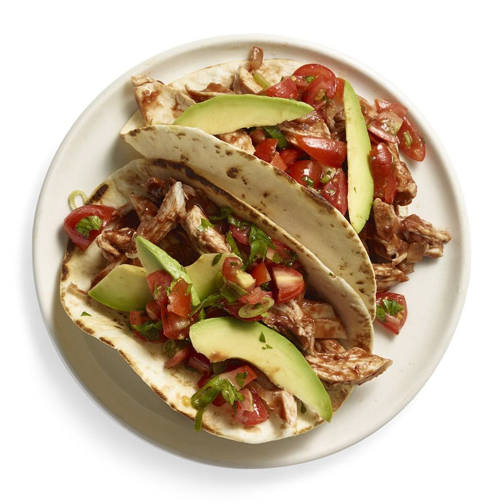 peanut butter and chipotle chicken tacos with sliced avocado on top