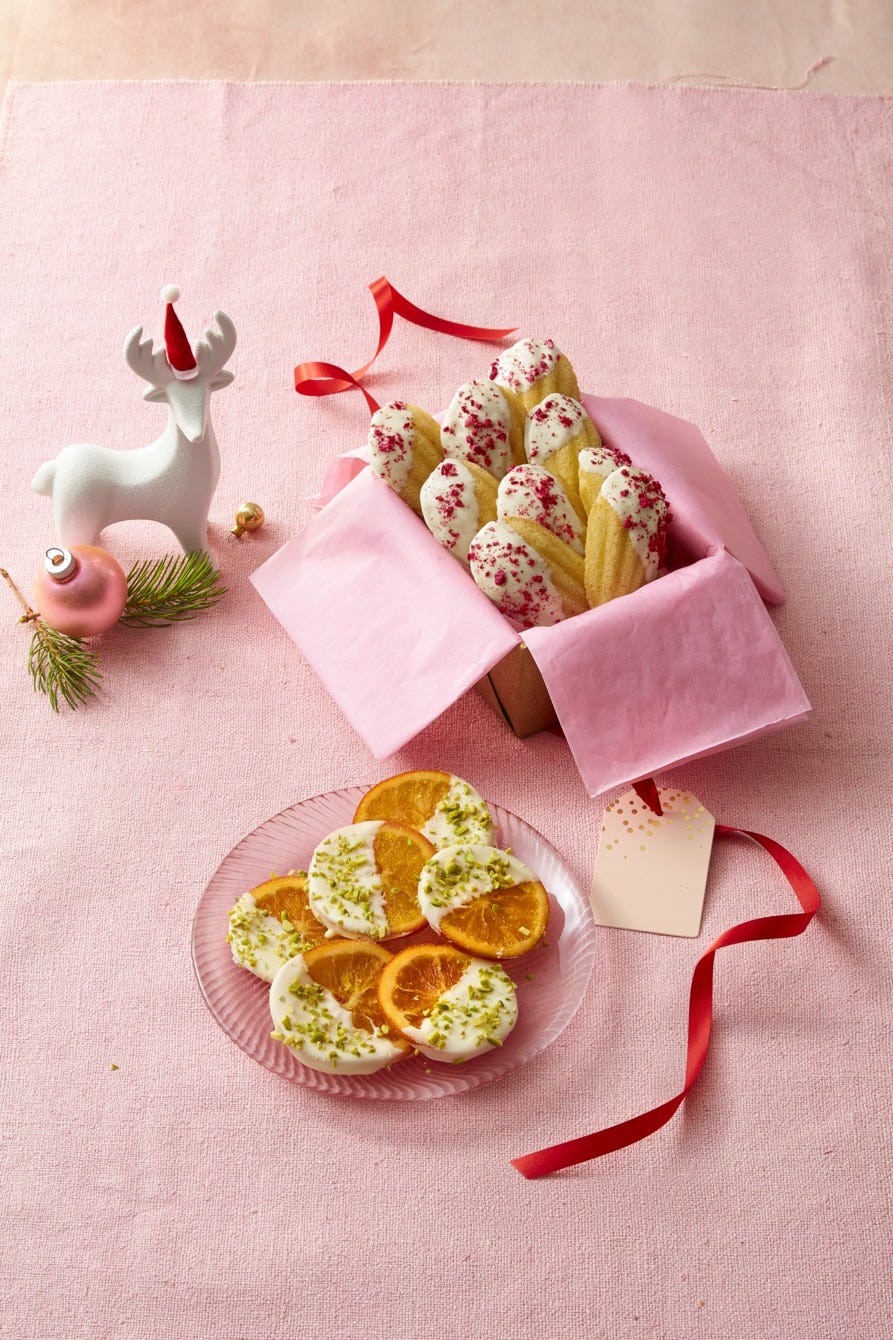 orange slices dipped in chocolate with pistachio sprinkle on top