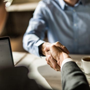 person shaking hands on a car loan person shaking hands on a car loan