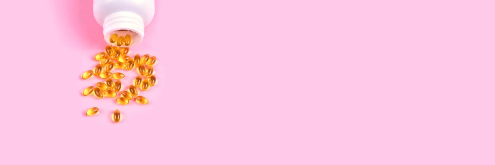 web banner with fish oil supplements in a white bowl on pink background