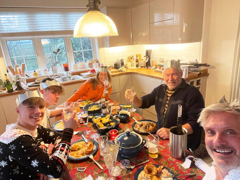 family and friends gathered around a dining table enjoying a festive meal