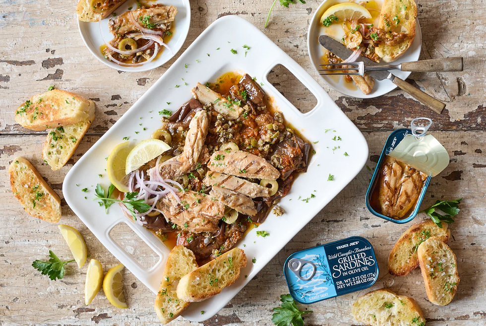 trader joe's wild caught boneless grilled sardines in olive oil shown in recipe for grilled sardines mezze plate with grecian style eggplant with tomatoes  onions, olive tapenade, red onion and parsley served with toasted ciabatta baguette slices
