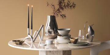travertine table piled with luxury tableware