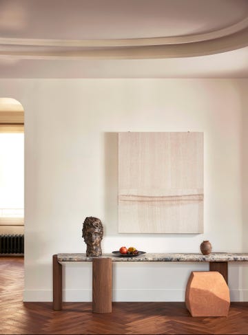 low marble topped console with objet and artwork above
