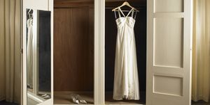 wedding dress hanging in wardrobe with shoes