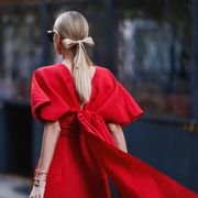 new york, new york   february 14 leonie hanne wearing a red dress, a black bag outside carolina herrera during new york fashion week on february 14, 2022 in new york city photo by jeremy moellergetty images
