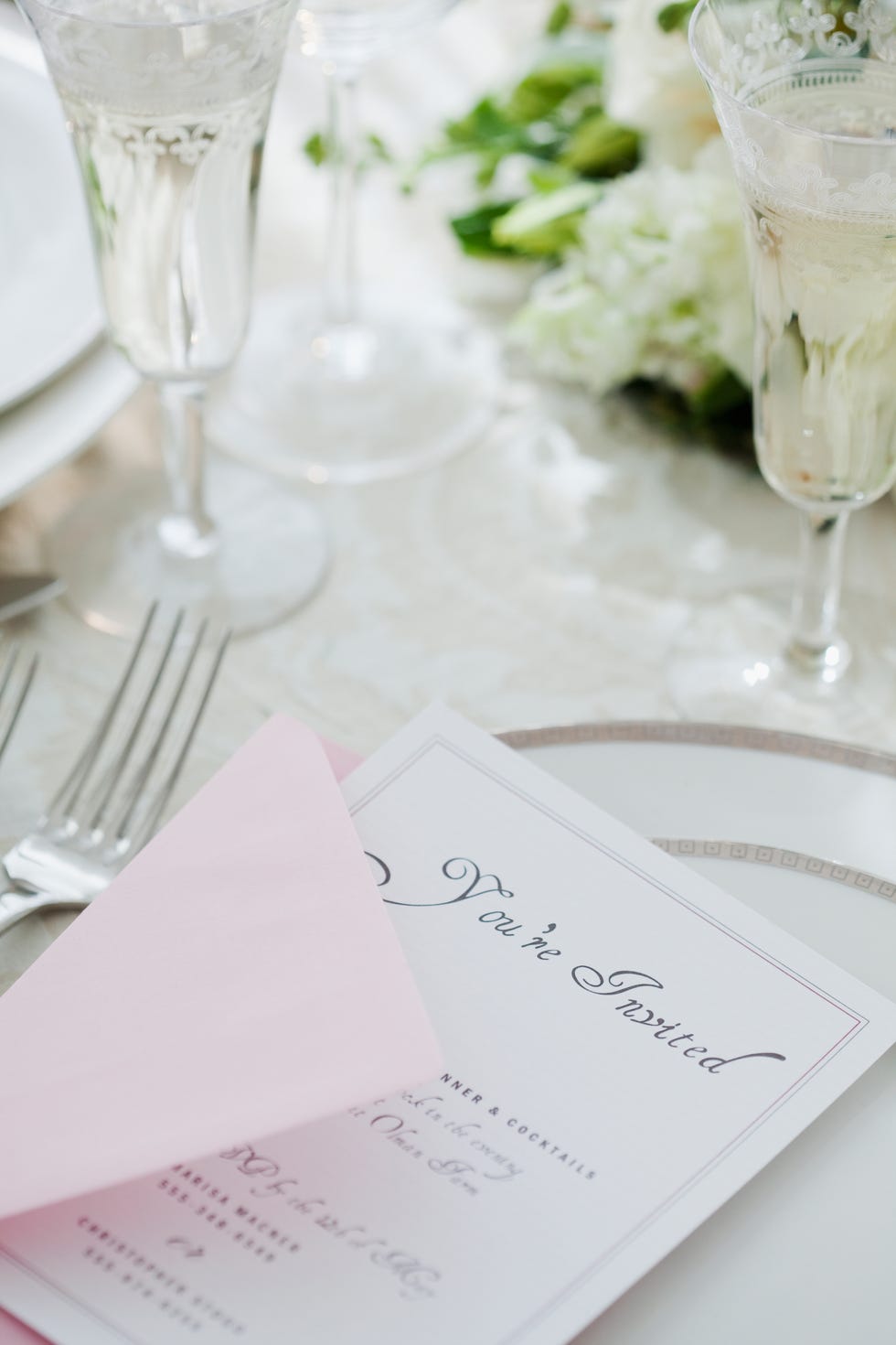 Wedding invitation on laid table, studio shot