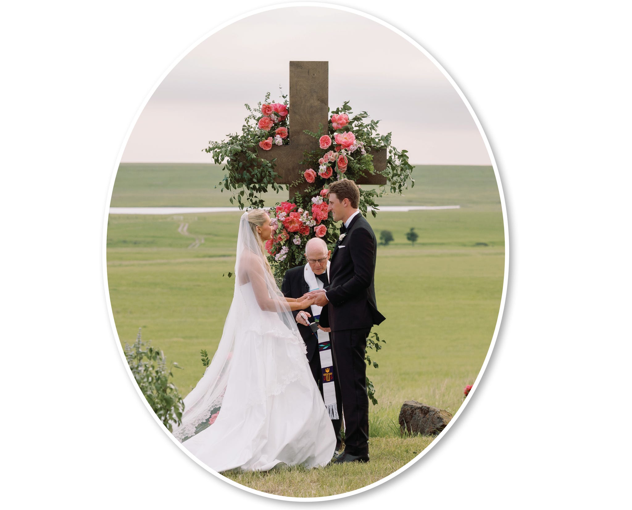 wedding ceremony taking place outdoors with a floral altar