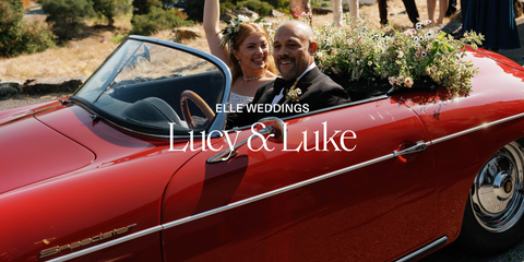 a wedding couple in a red convertible