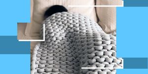 person sleeping under weighted knit blanket