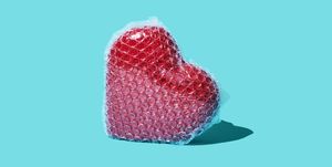 a red ceramic heart wrapped in bubble wrap on a blue background heart health