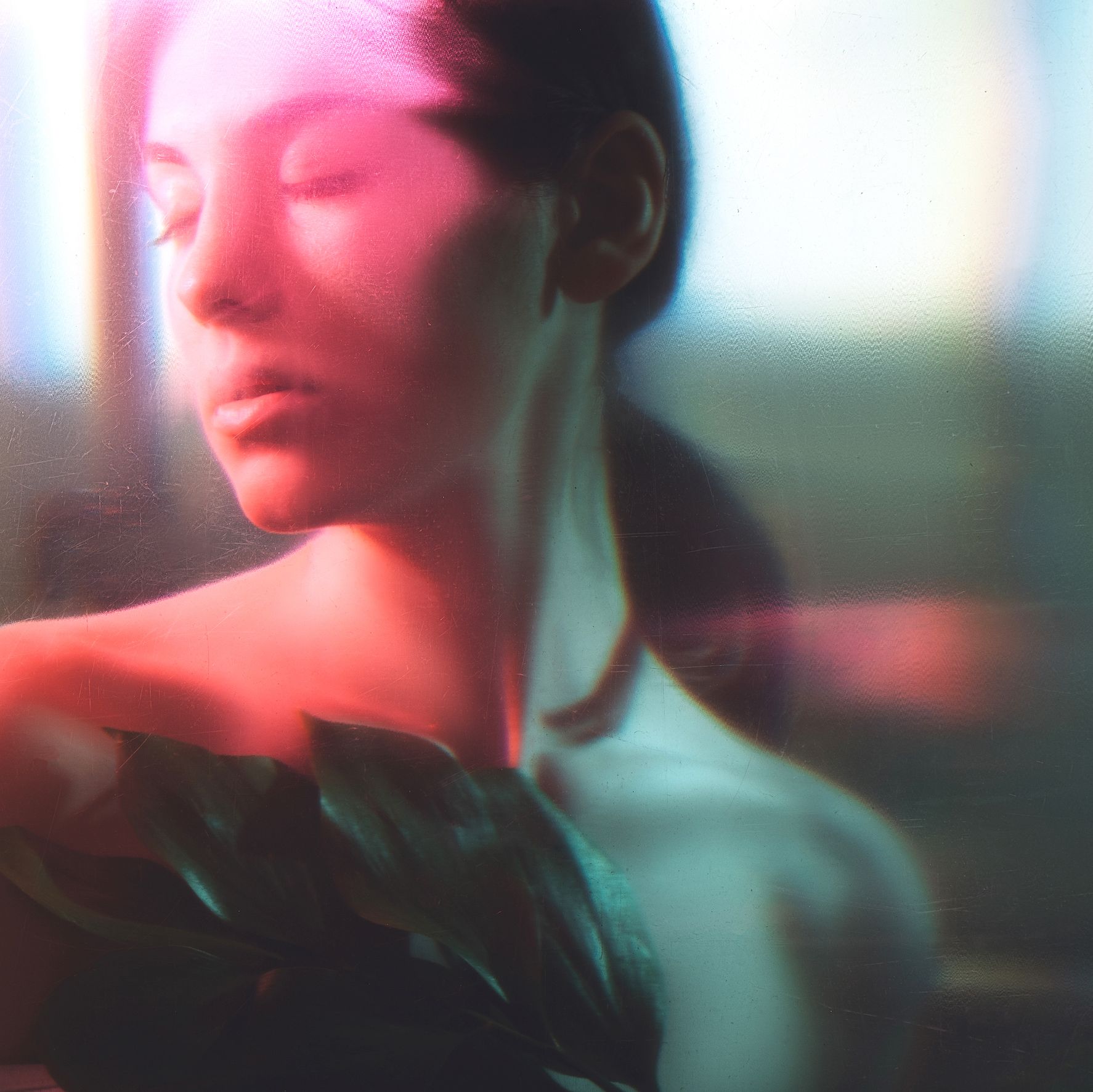 woman with bare shoulders and a blurred silhouette in neon red light to effect tranquility and relaxation