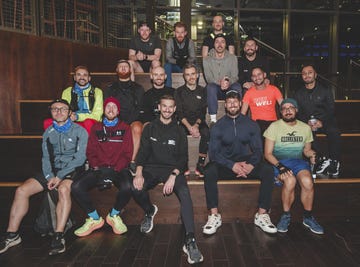 a group of runners sitting together on some large steps