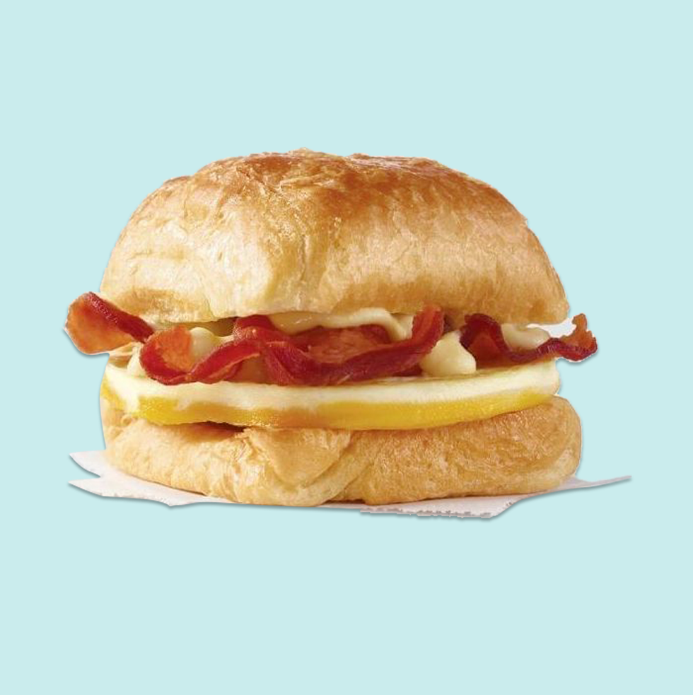 wendy's bacon, egg  swiss croissant on a blue background