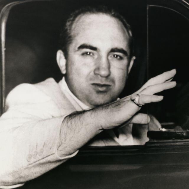 gangster mickey cohen waving good bye from vehicle