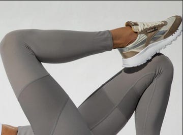 legs wearing gray athletic leggings and stylish sneakers