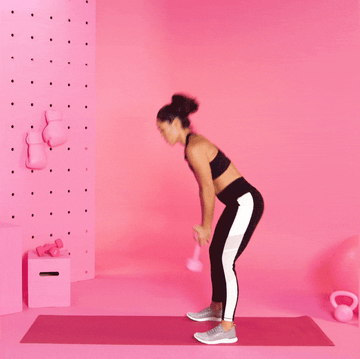 trainer Charlee Atkins performing dumbbell swing trainer charlee atkins performing dumbbell swing