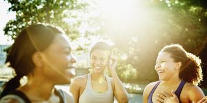 friends laughing together after morning run in downtown neighborhood