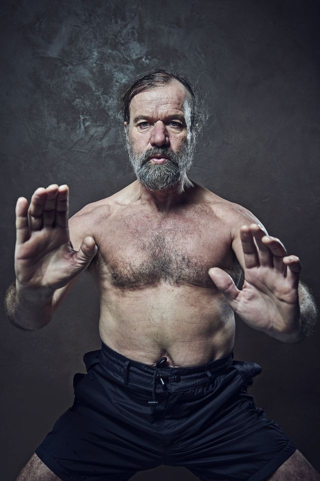 topless male middle aged bearded man standing with his hands outstretched