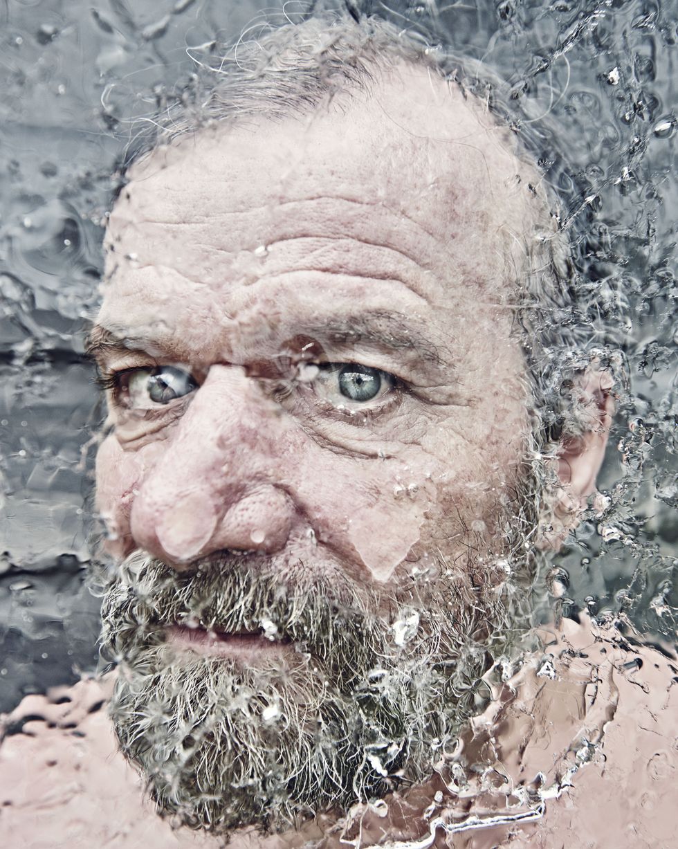 bearded middle aged man standing behind some ice