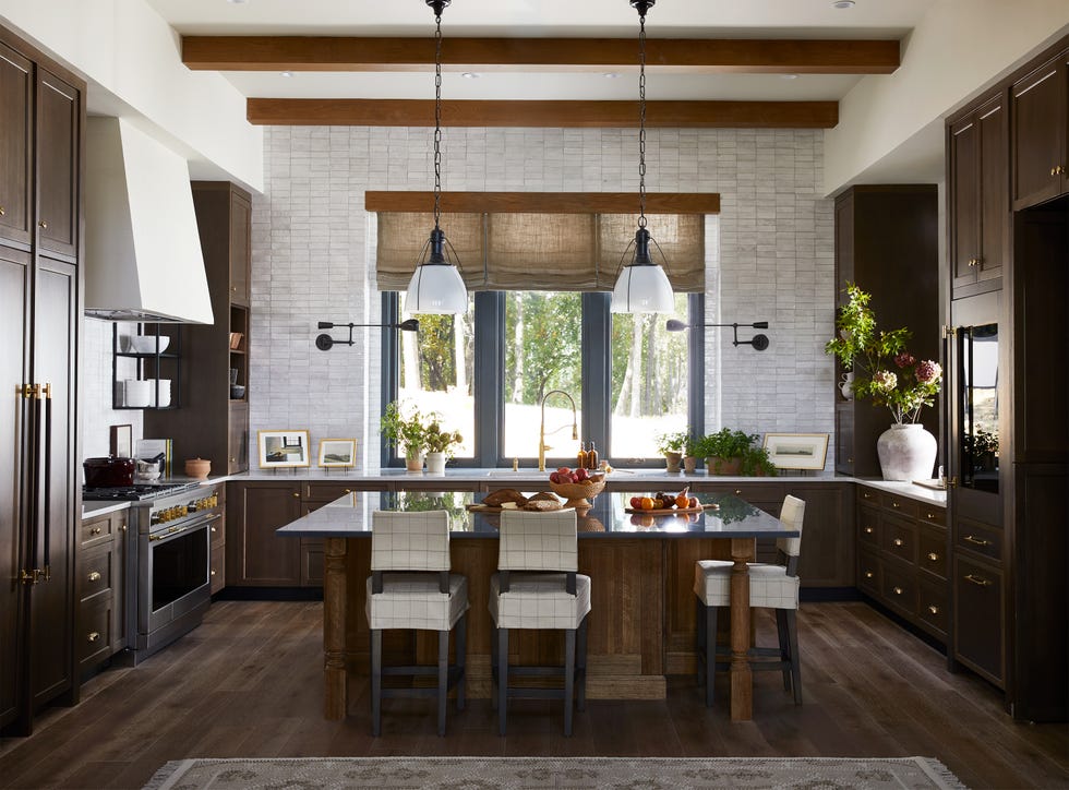 modern kitchen with dark cabinetry and island featuring a bowl of fruit