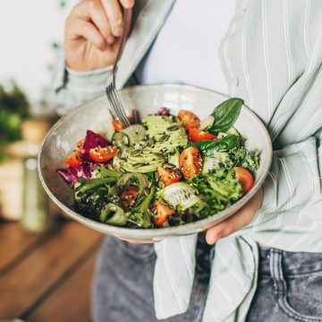 a woman holds a salad