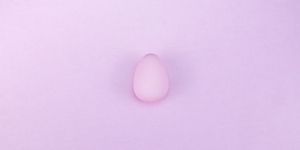 wondering, what does ovulation mean a pink egg lies on a pastel pink background
